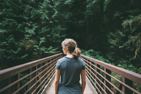A woman standing on a bridge.