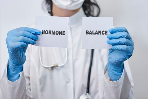 doctor holding sign about hormone balance