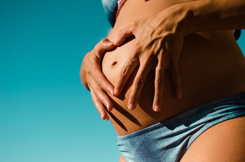 Pregnant woman touching stomach
