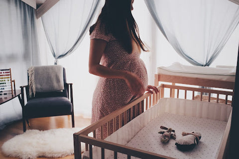 pregnant woman in baby's bedroom